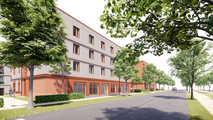 2 vieretagige Wohnblöcke direkt an einer Straße mit orangefarbener Gewerbezeile im Erdgeschoss