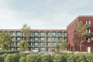 Eine Häuserzeile mit einem roten Gebäude auf der rechten Seite. 
